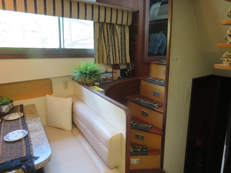 Slide: The Image of Interior of 1986 Hatteras 58 Motor Yacht with dining area and staircase. - 20