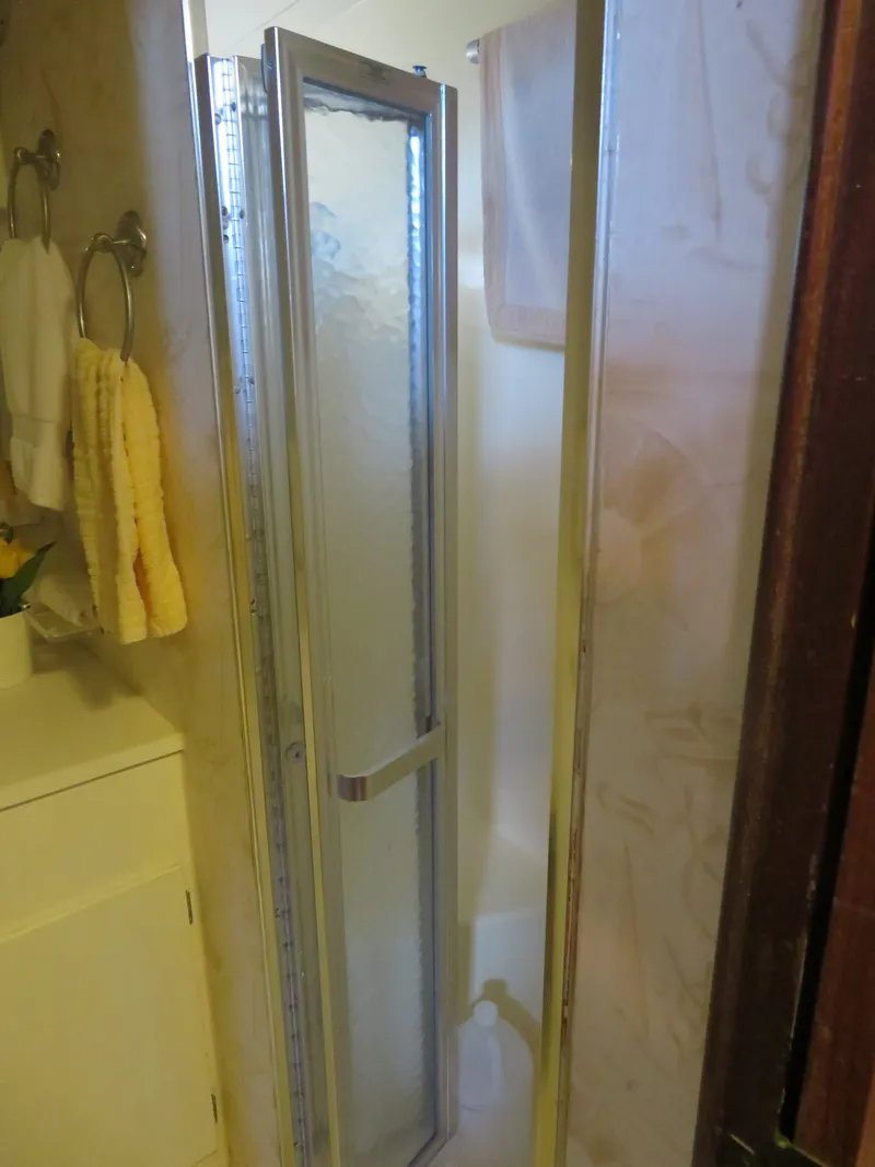 Slide: The Image of Shower area in 1986 Hatteras 58 Motor Yacht with glass door and towel rack. - 27