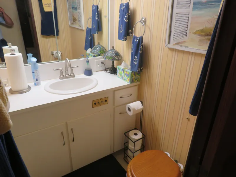 Slide: The Image of Bathroom interior of 1986 Hatteras 58 Motor Yacht with nautical decor and wooden accents. - 29