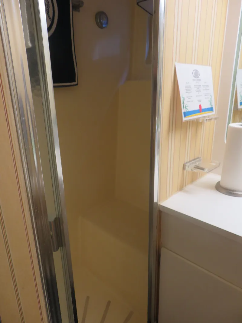 Slide: The Image of Shower area inside 1986 Hatteras 58 Motor Yacht with striped wallpaper and countertop. - 30