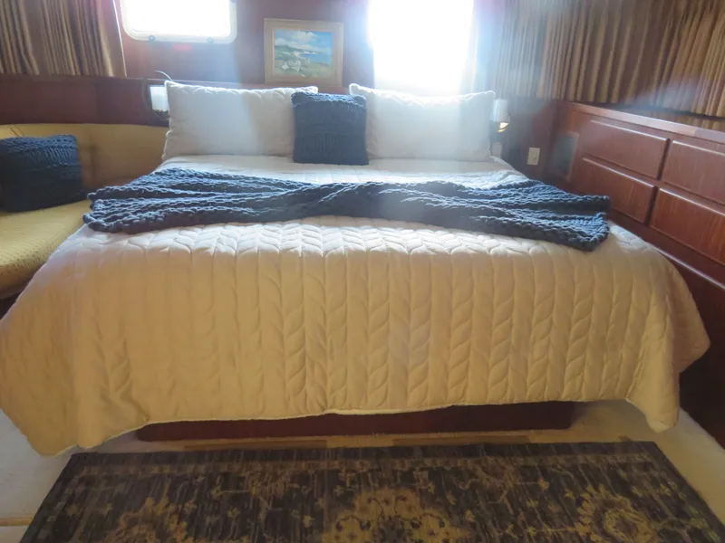 Slide: The Image of Luxurious bedroom interior of 1986 Hatteras 58 Motor Yacht with cozy bedding and decor. - 34