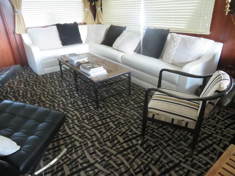 Slide: The Image of Luxurious interior of 1986 Hatteras 58 Motor Yacht with elegant seating and decor. - 4