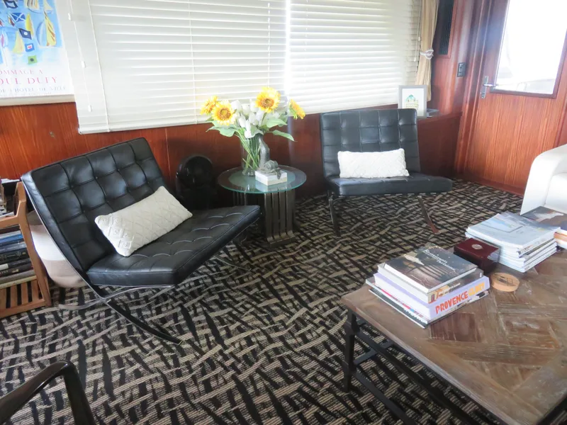 Slide: The Image of Interior of 1986 Hatteras 58 Motor Yacht with modern chairs and sunflowers. - 5