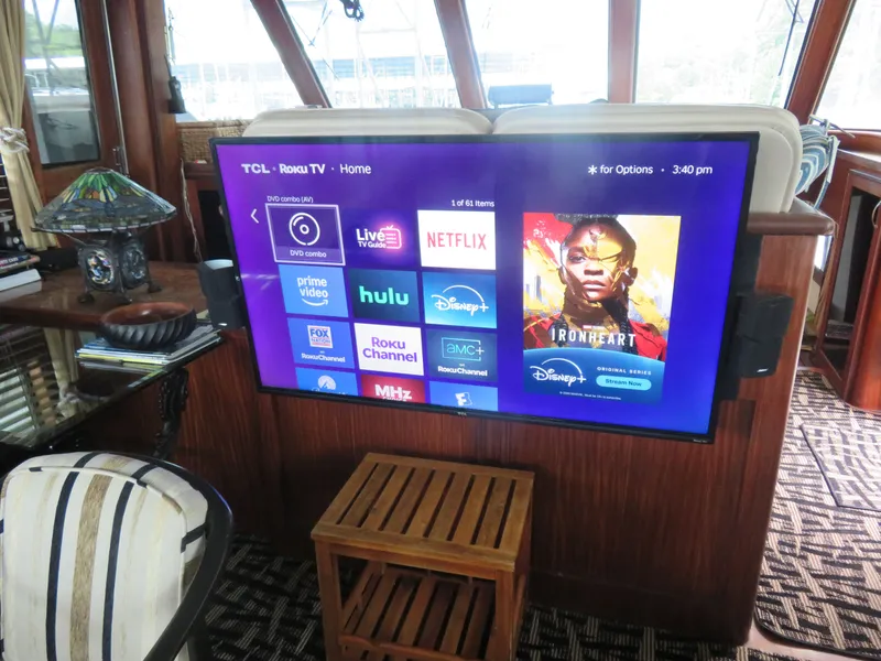Slide: The Image of 1986 Hatteras 58 Motor Yacht interior with mounted Roku TV displaying streaming apps. - 6