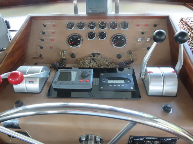 Slide: The Image of Control panel of a 1986 Hatteras 58 Motor Yacht with gauges and levers. - 8