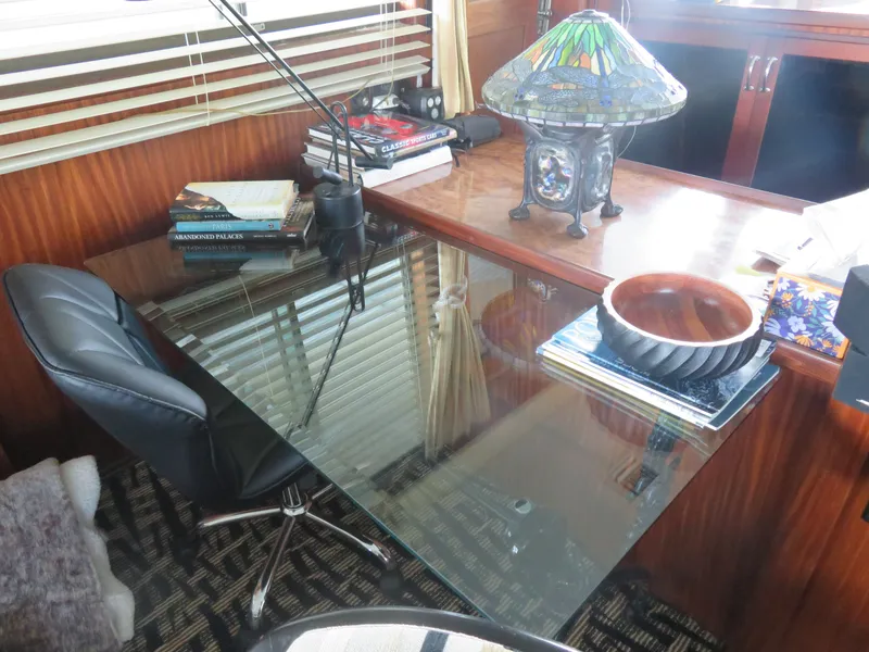 Slide: The Image of Office space on 1986 Hatteras 58 Motor Yacht with glass desk and decorative lamp. - 9