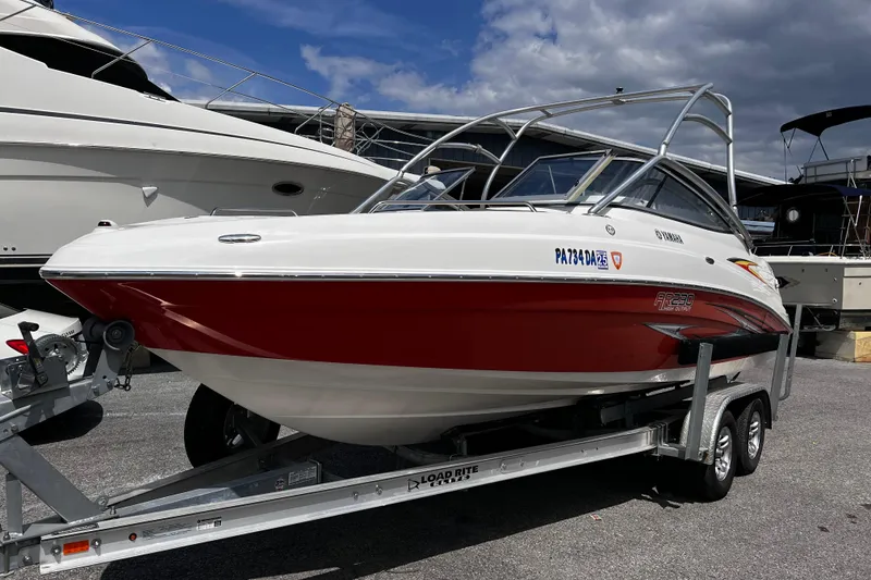 Slide: The Image of 2007 Yamaha Boats AR230 HO on trailer, red and white design, parked outdoors. - 1