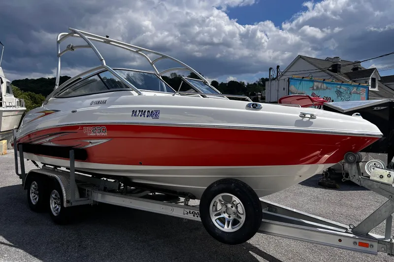 Slide: The Image of 2007 Yamaha Boats AR230 HO on trailer, red and white design, parked outdoors. - 2
