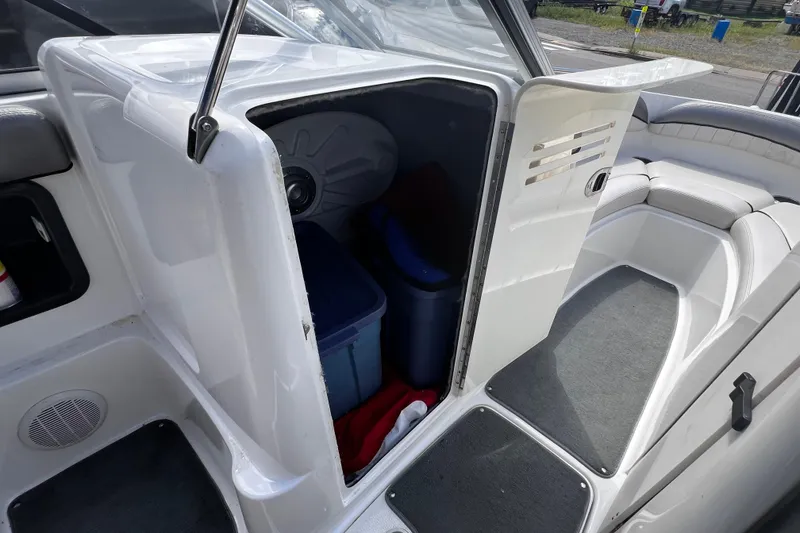 Slide: The Image of 2007 Yamaha Boats AR230 HO interior storage compartment with open door and seating area. - 7