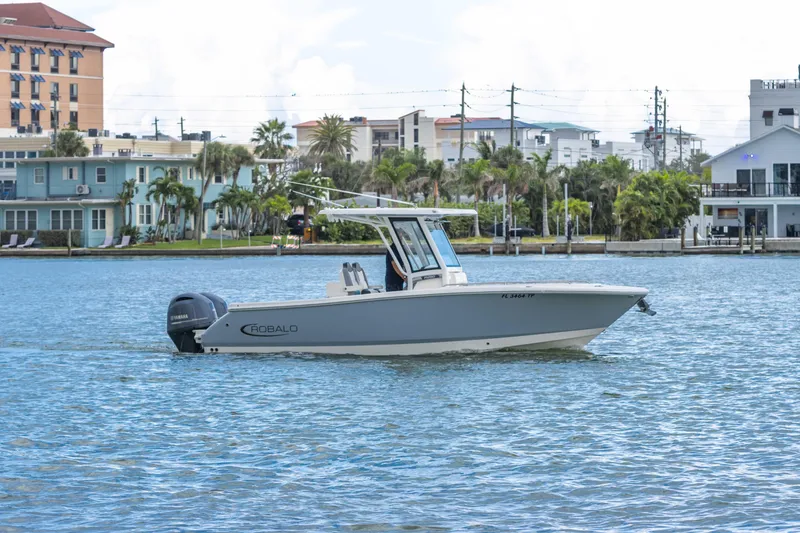 Slide: The Image of 2023 Robalo R250 Center Console boat cruising on a scenic waterfront. - 17
