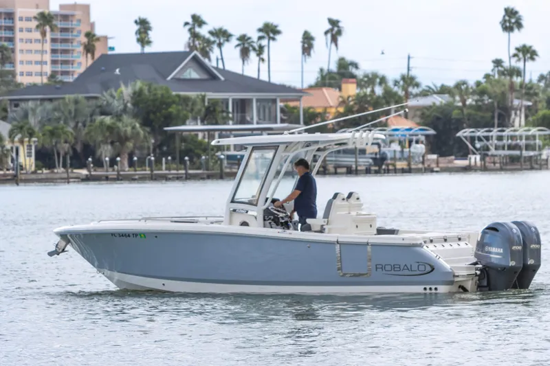 Slide: The Image of 2023 Robalo R250 Center Console boat cruising on a scenic waterway. - 25