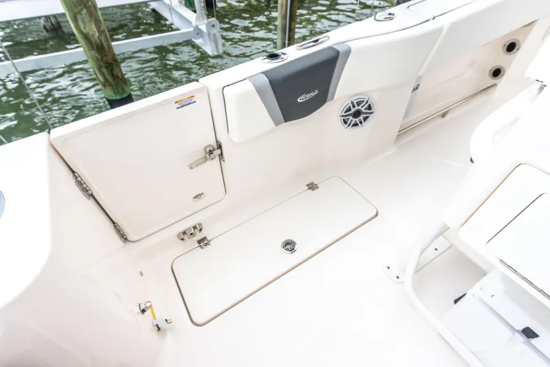 Slide: The Image of 2023 Robalo R250 Center Console boat deck with storage compartments and speaker. - 62