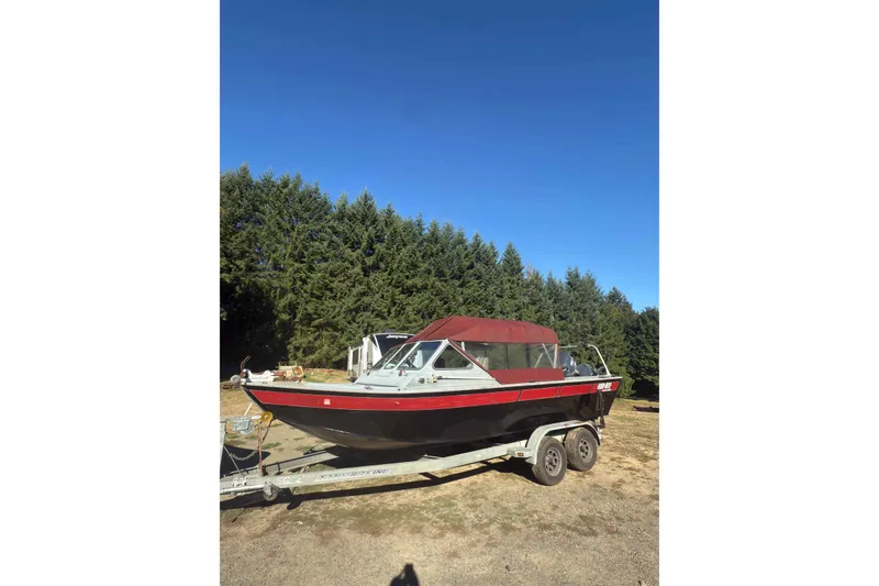 The Image of 1991 Fish Rite 22 Custom boat on trailer, parked outdoors with trees in background. - 1