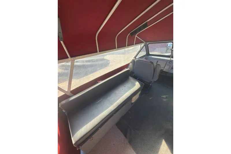 Slide: The Image of Interior of 1991 Fish Rite 22 Custom boat with red canopy and seating. - 10