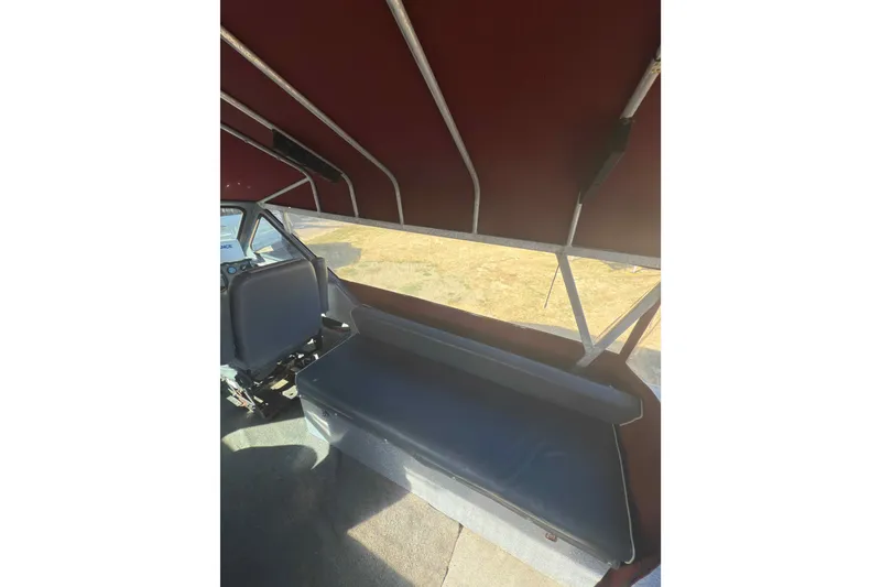 Slide: The Image of Interior of 1991 Fish Rite 22 Custom boat with maroon canopy and seating. - 11
