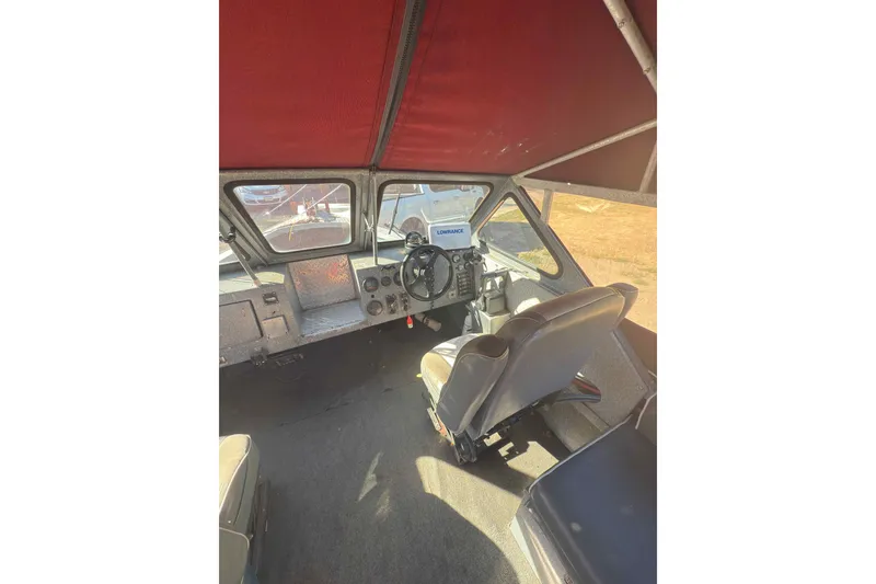 Slide: The Image of Interior of a 1991 Fish Rite 22 Custom boat with steering wheel and dashboard. - 13