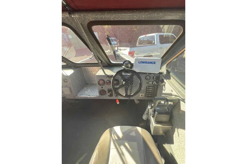 Slide: The Image of Interior of a 1991 Fish Rite 22 Custom boat with steering wheel and Lowrance equipment. - 14