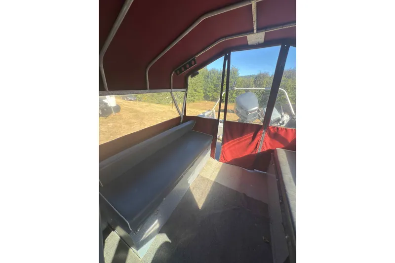 Slide: The Image of Interior of 1991 Fish Rite 22 Custom boat with red canopy and seating. - 19