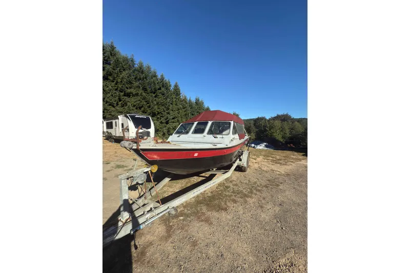 Slide: The Image of 1991 Fish Rite 22 Custom boat on trailer, parked outdoors under clear blue sky. - 2