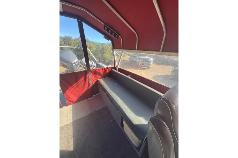 Slide: The Image of Interior of 1991 Fish Rite 22 Custom boat with red canopy and seating. - 20