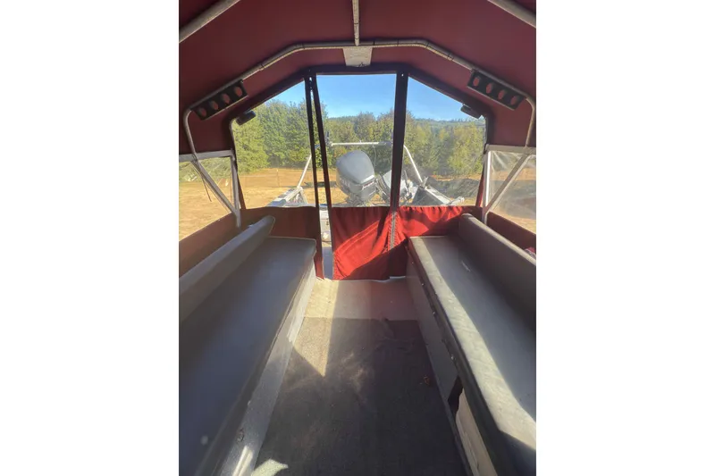Slide: The Image of Interior view of 1991 Fish Rite 22 Custom boat with red canopy and seating. - 21