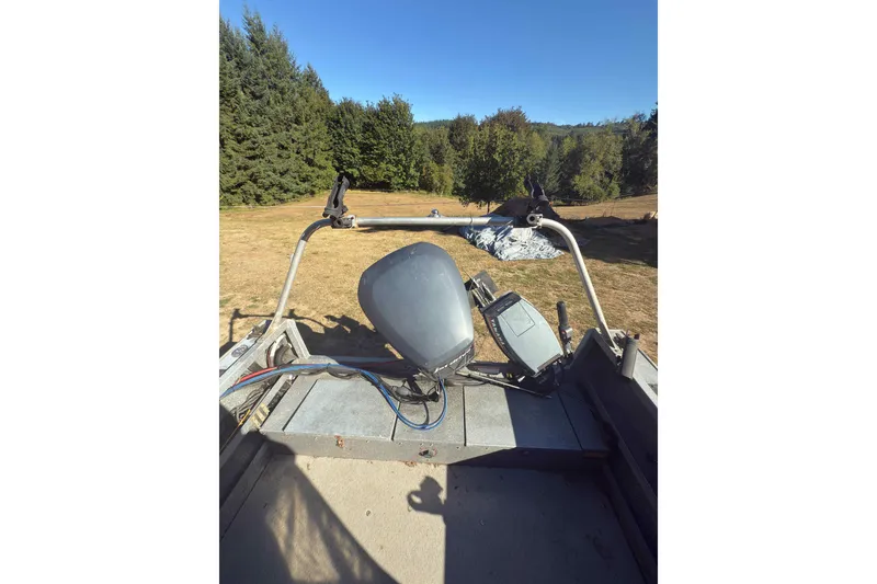 Slide: The Image of 1991 Fish Rite 22 Custom boat interior with steering wheel and control panel. - 22