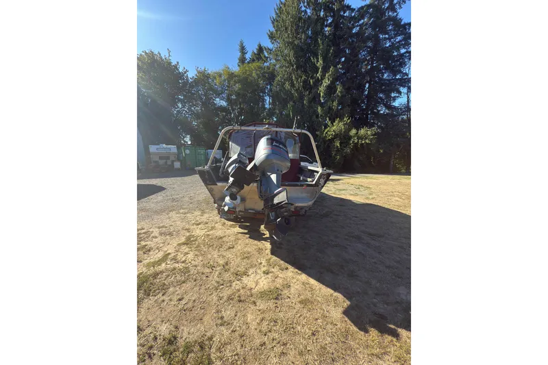 Slide: The Image of 1991 Fish Rite 22 Custom boat with dual outboard motors in a sunny outdoor setting. - 4