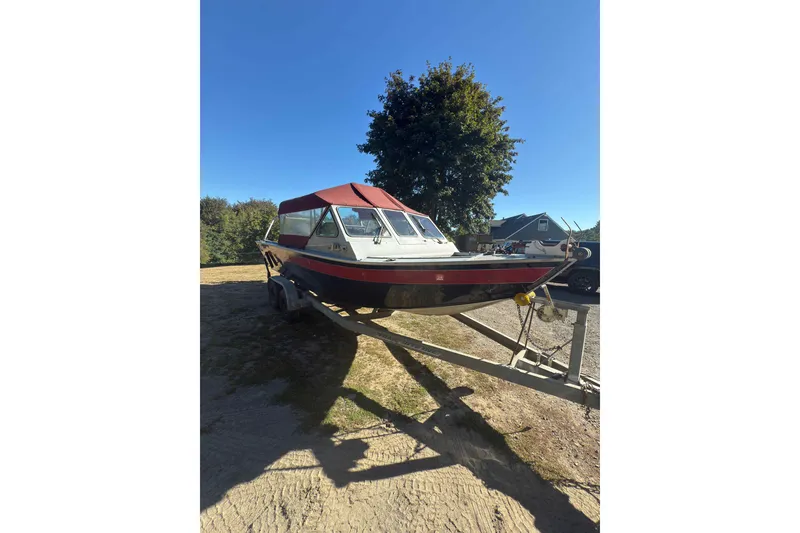 Slide: The Image of 1991 Fish Rite 22 Custom boat on trailer, red canopy, parked outdoors. - 5