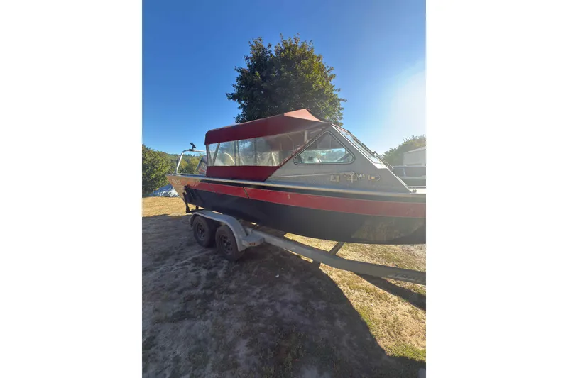 Slide: The Image of 1991 Fish Rite 22 Custom boat on trailer, parked outdoors under clear blue sky. - 6