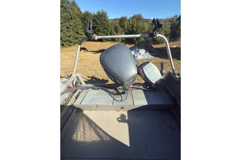 Slide: The Image of 1991 Fish Rite 22 Custom boat with motor, set in a grassy outdoor area. - 7
