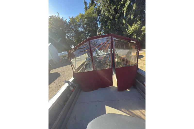 Slide: The Image of 1991 Fish Rite 22 Custom boat with maroon canopy in a sunny outdoor setting. - 8
