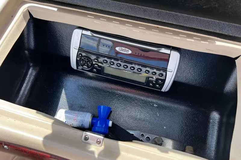 Slide: The Image of 2004 Glastron GX 185 boat glove compartment with Clarion stereo and accessories. - 10