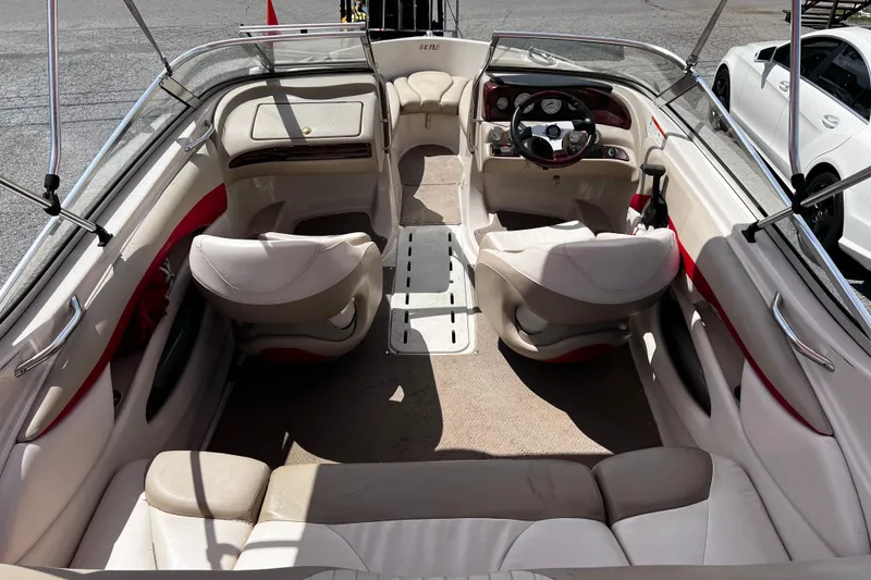 Slide: The Image of 2004 Glastron GX 185 boat interior with beige seating and steering console. - 5