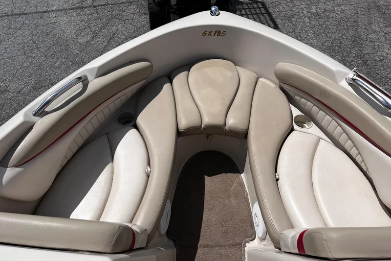 Slide: The Image of 2004 Glastron GX 185 boat interior with beige seating and cup holders. - 7