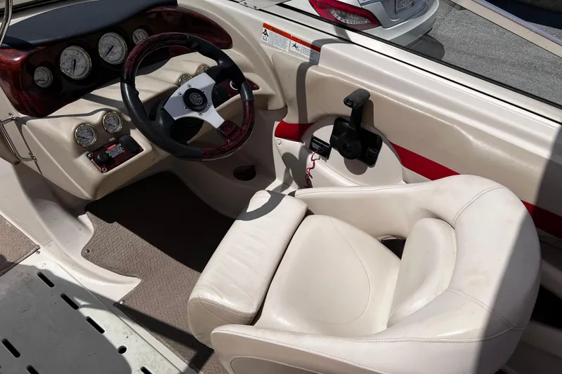 Slide: The Image of 2004 Glastron GX 185 boat interior with steering wheel and gauges. - 8