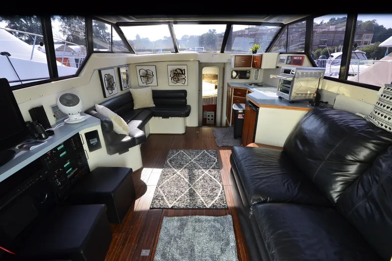 Slide: The Image of 1988 Mainship Mediterranean Convertible yacht interior with modern furnishings and panoramic windows. - 11