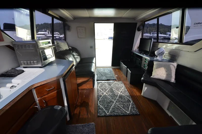 Slide: The Image of Interior of 1988 Mainship Mediterranean Convertible yacht with modern amenities and cozy seating. - 12