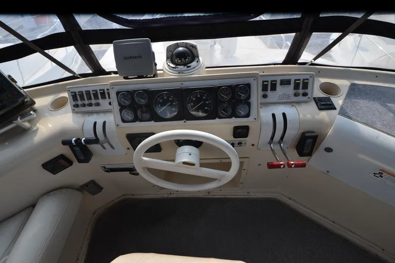 Slide: The Image of 1988 Mainship Mediterranean Convertible helm with steering wheel, gauges, and navigation equipment. - 5