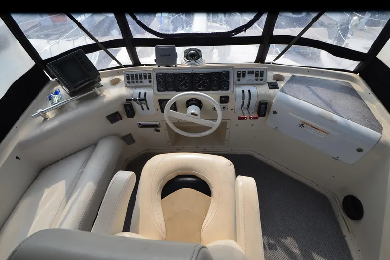 Slide: The Image of 1988 Mainship Mediterranean Convertible helm with steering wheel, gauges, and navigation equipment. - 6