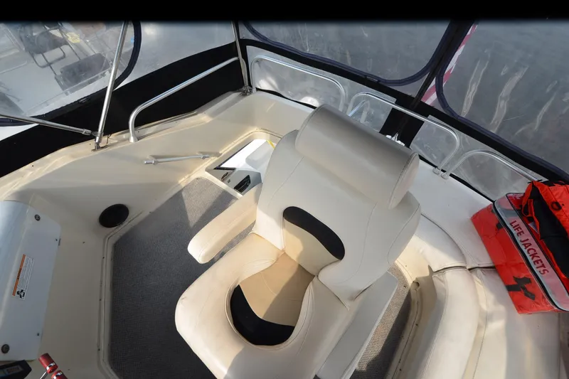 Slide: The Image of 1988 Mainship Mediterranean Convertible boat interior with captain's chair and life jackets. - 7