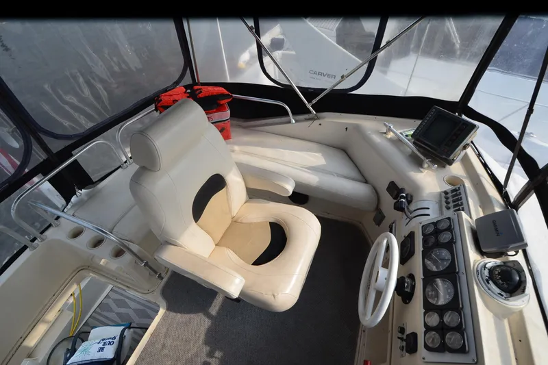 Slide: The Image of 1988 Mainship Mediterranean Convertible helm with captain's chair, navigation equipment, and control panel. - 8