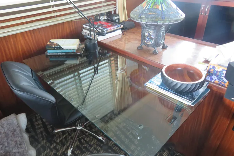 Slide: The Image of Interior of 1986 Hatteras 58 Motor Yacht with glass desk, books, and decorative lamp. - 10