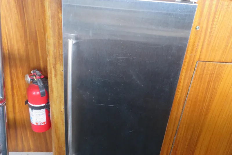 Slide: The Image of Fire extinguisher and metal panel on 1986 Hatteras 58 Motor Yacht interior. - 13