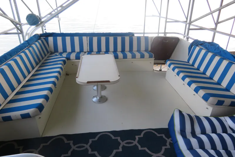 Slide: The Image of Interior of 1986 Hatteras 58 Motor Yacht with striped seating and table. - 14