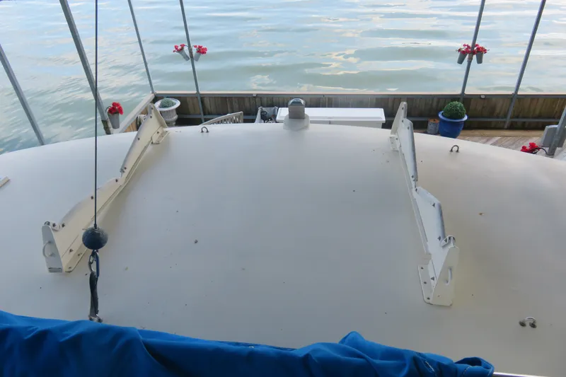 Slide: The Image of 1986 Hatteras 58 Motor Yacht deck with lake view and decorative plants. - 17