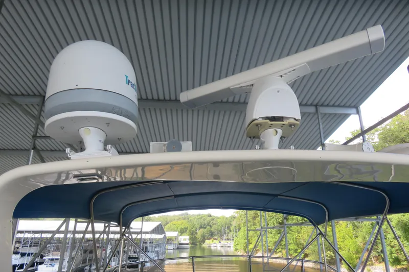 Slide: The Image of 1986 Hatteras 58 Motor Yacht radar and satellite equipment under covered dock. - 19