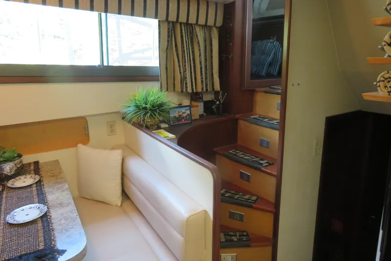 Slide: The Image of Interior of 1986 Hatteras 58 Motor Yacht with dining area and staircase. - 21