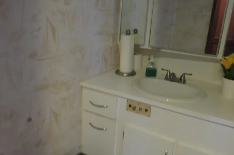 Slide: The Image of Bathroom vanity in 1986 Hatteras 58 Motor Yacht with sink, faucet, and floral decor. - 27