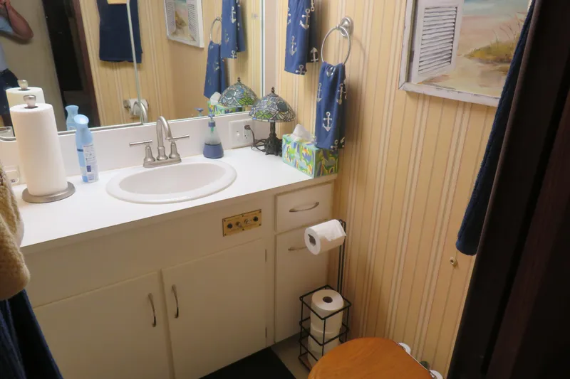 Slide: The Image of Bathroom interior of 1986 Hatteras 58 Motor Yacht with nautical decor and vanity sink. - 30