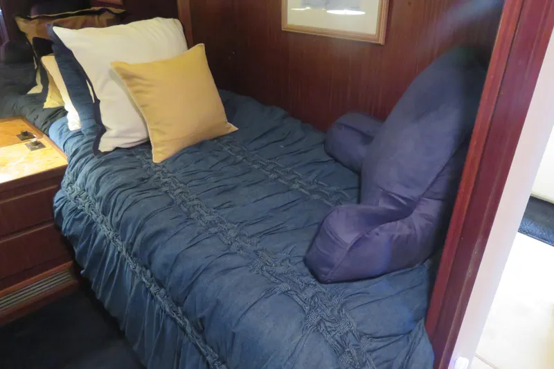 Slide: The Image of Cozy cabin bed with blue bedding on 1986 Hatteras 58 Motor Yacht. - 33